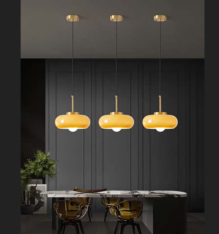 mustard pendant light hanging on a minimalist dining room