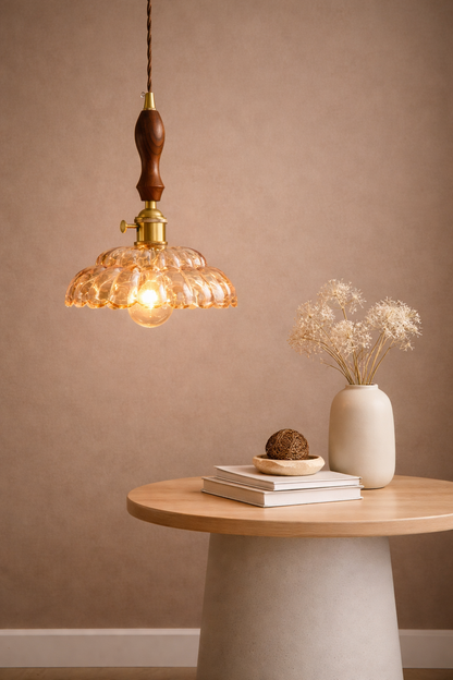 Amber glass pendant light with a retro-inspired  shade and antique brass hardware.
