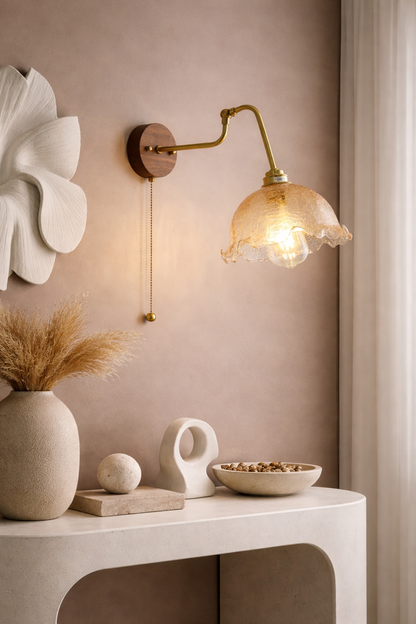 Bedside antique brass wall lamp featuring a clear glass shade, walnut wood base, and pull chain, perfect for farmhouse or industrial decor