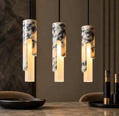 Long slim tube pendant light with integrated LED hanging above a dining table, creating a modern luxury dining atmosphere with warm ambient lighting.