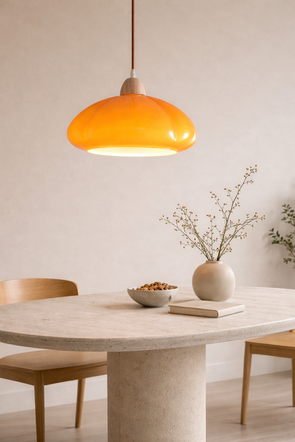 Bold mustard yellow organic pendant light hanging over a dining table, providing a warm and colorful focal point