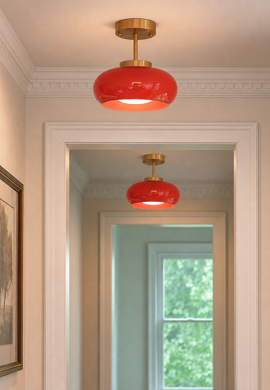 Red Glass semi-flush mount ceiling light with  brushed brass fixture, shown installed in a hallway.