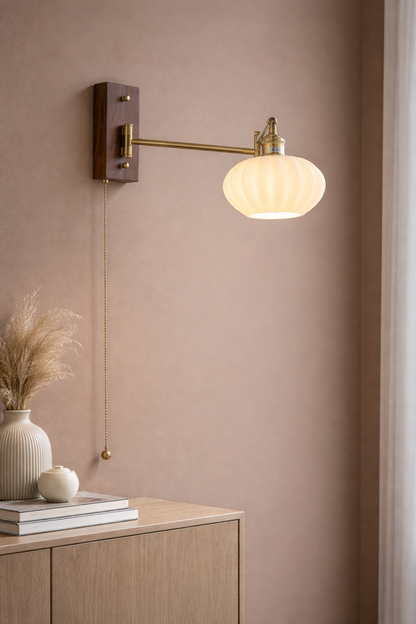 Mashal Designs Antique Brass swing arm ceramic wall sconce mounted on wooden base. Provides flexible, adjustable task lighting for a reading nook or bedside.