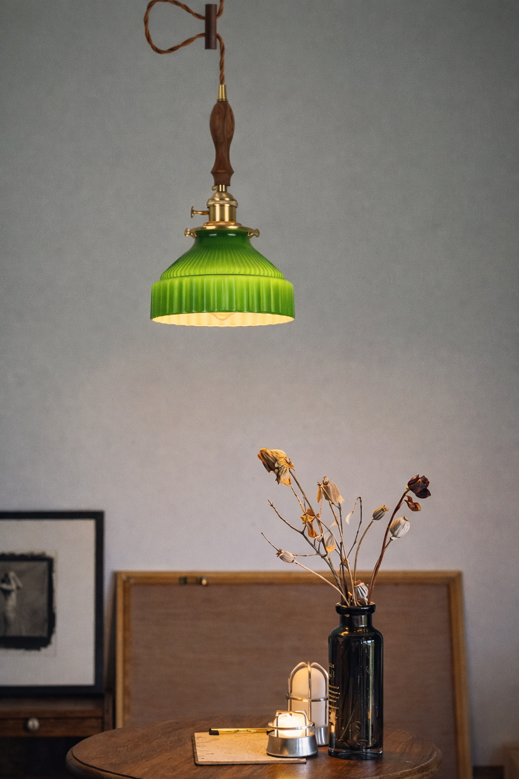 Detail of the vertical ribbed texture on a hand-blown green glass shade for a mid-century modern look.