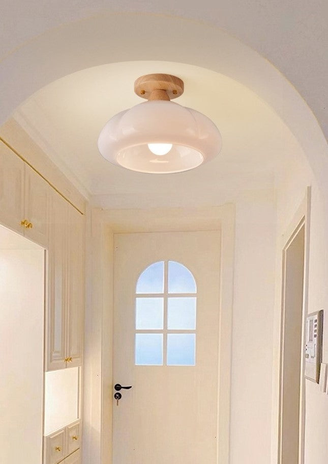A flowing, organic white flush-mount ceiling fixture providing soft light in a  Entryway