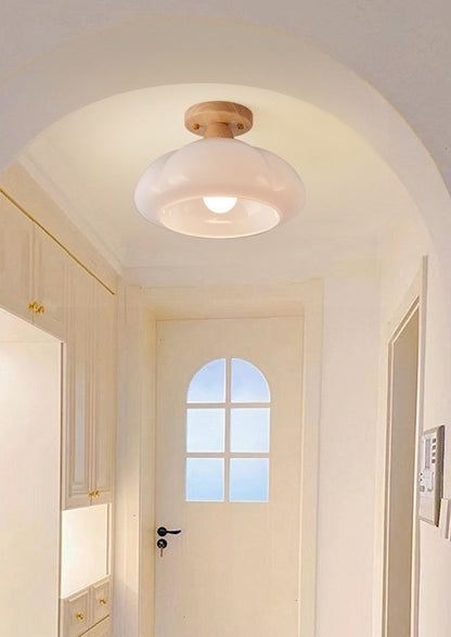 A flowing, organic white flush-mount ceiling fixture providing soft light in a  Entryway