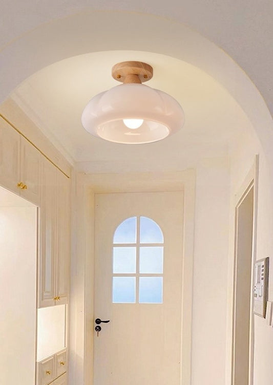 A flowing, organic white flush-mount ceiling fixture providing soft light in a  Entryway