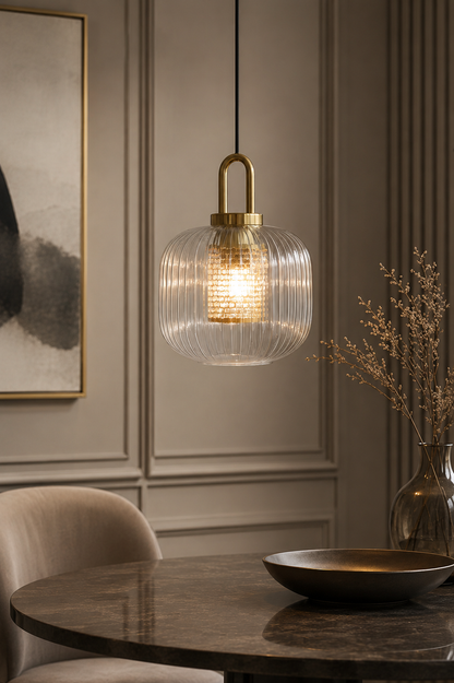 Textured ribbed glass globe pendant over a wooden dining room table – A decorative spherical hanging light with water-like glass patterns, adding a mid-century modern touch to a central dining area.