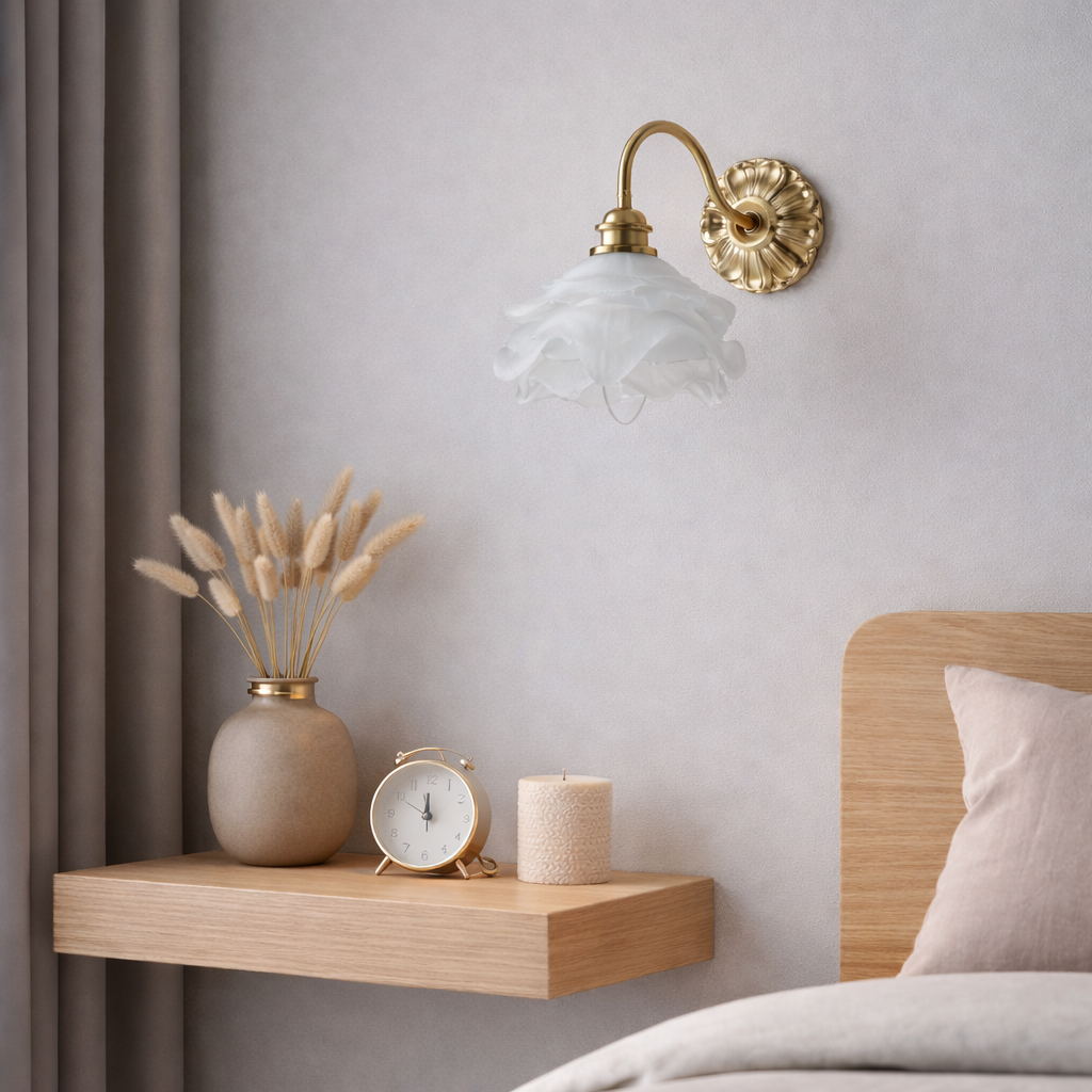 Classic antique brass wall sconce with detailed floral glass shade