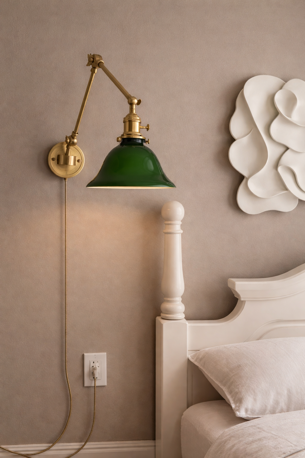 Plug-in brass swing arm wall light with green glass shade and cord cover