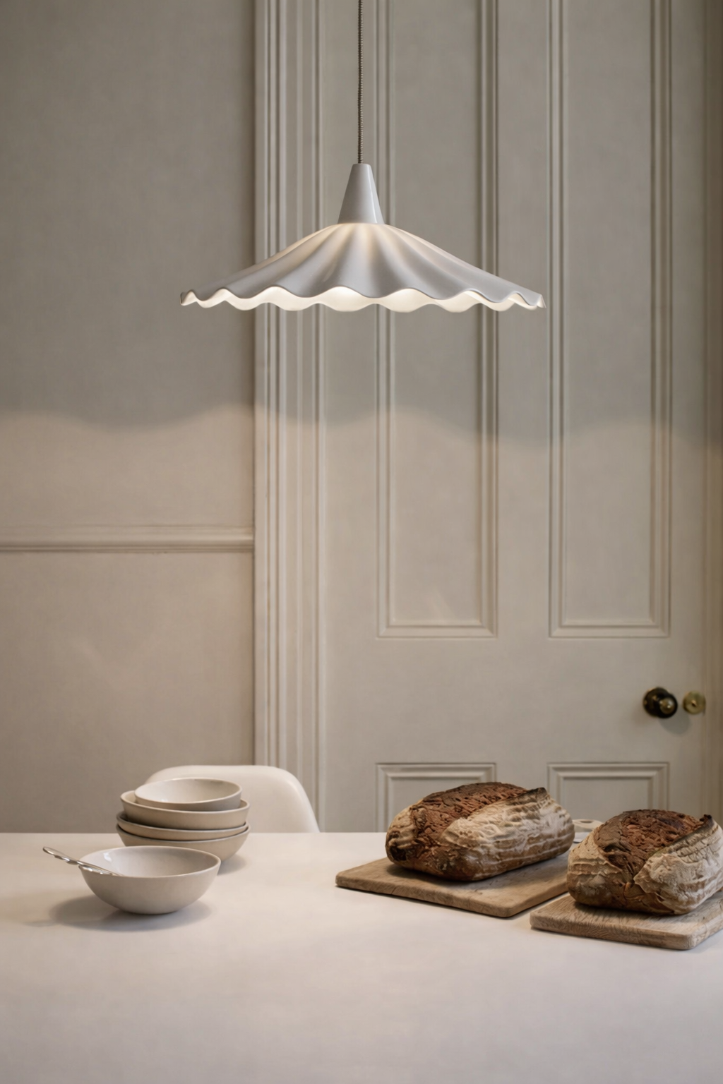 Contemporary white pendant ceiling light hanging over kitchen Island
