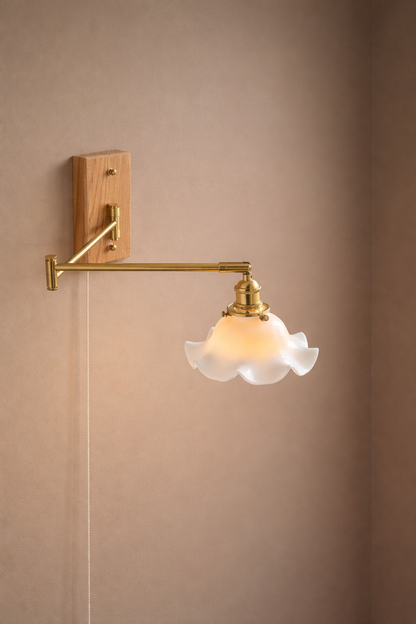 Wall-mounted antique brass swing-arm light with ashwood oblong canopy and unique scalloped ceramic shade