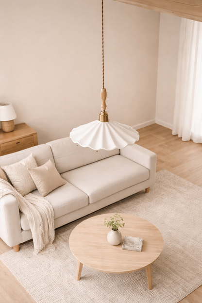 Mashal Designs scalloped porcelain pendant light hanging over a coffee tale in sitting room