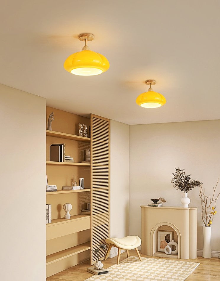 Mustard yellow organic ceiling fixture mounted along a neutrally decorated living space