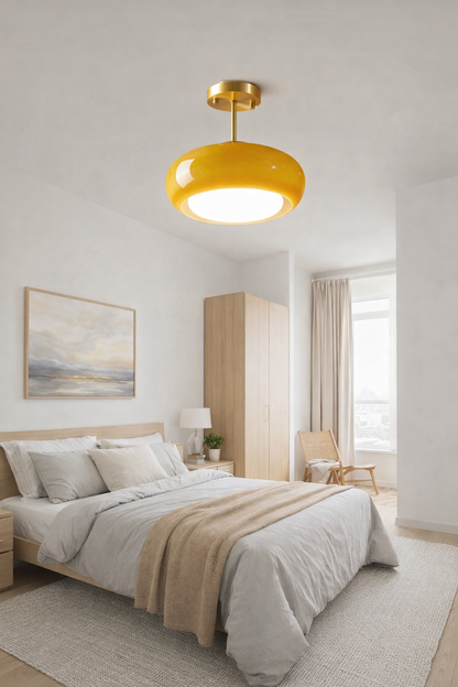 Modern luxury mustard yellow flush mount light with brass accents, hanging in Bedroom